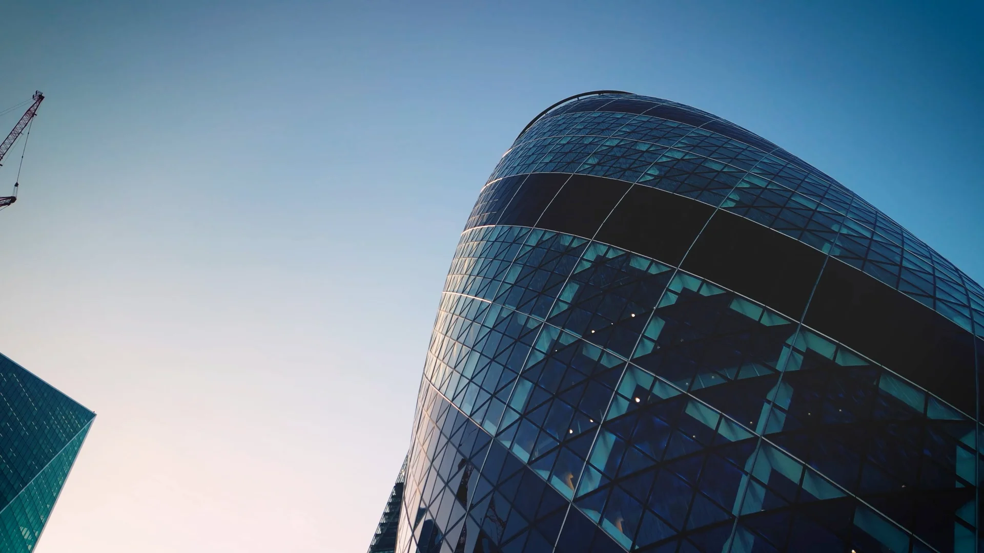 Evening light moving across a curved glass facade
